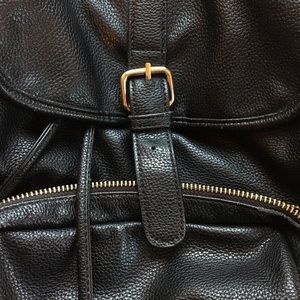 Black faux leather backpack with gold detailing